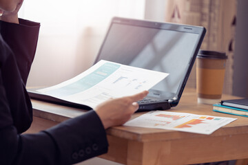 Businesswoman hands holding business documents papers, financial statistics reports graphs and charts at the office