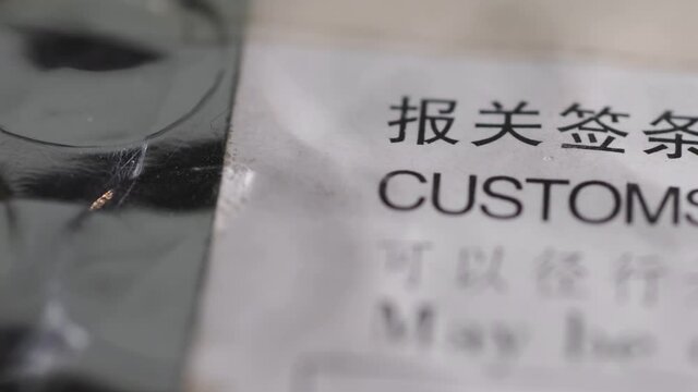 closeup footage of postal envelope with customs declaration sign, tracking camera motion
