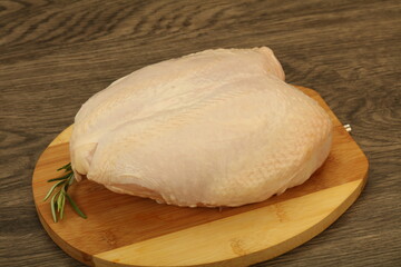 Raw whole chicken breast with skin