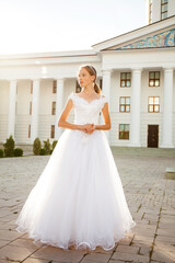 Fototapeta premium Portrait of a young woman in a white ball gown