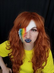 Fototapeta premium Photo of the Girl. Portrait. Red hair. makeup. emotions. Rainbow