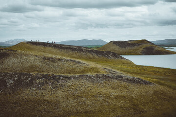 The coastline around the pond Stakholstjorn with pseudo craters - natural monument near Lake Myvatn in Northern Iceland in summer