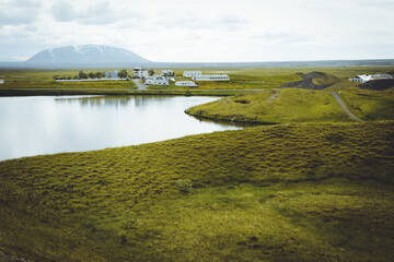 The coastline around the pond Stakholstjorn with pseudo craters - natural monument near Lake Myvatn in Northern Iceland in summer