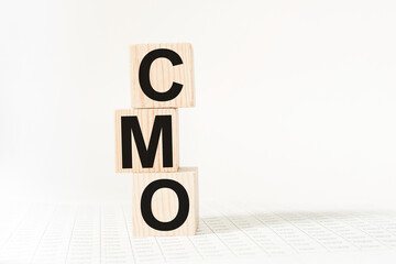 a word CMO on wooden cubes. business concept. business and Finance