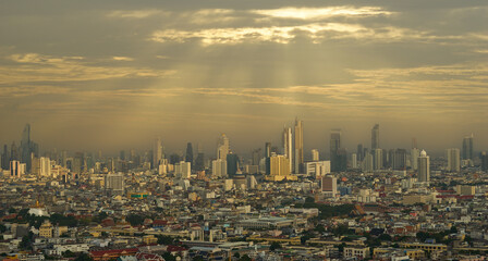 Bangkok cityscape with sun rays from cloud and skyline nearly sunset time