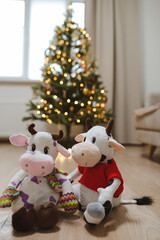 Toy bull against the blured Christmas tree lights. Symbol of the Chinese New year 2021. Merry Christmas and New year background