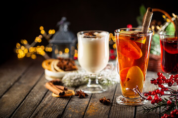 fresh yellow eggnog, grog and fruity red mulled wine with Christmas decoration. Selection of autumn or winter alcoholic hot drinks