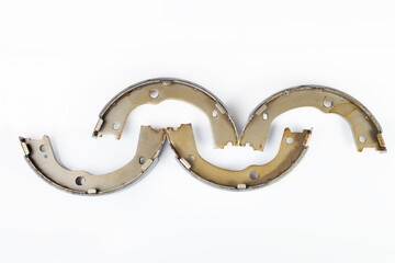 kit of four drum brake shoes with asbestos alloy on steel car spare parts pads isolated on white...