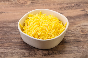 Shredded yellow cheese in the bowl