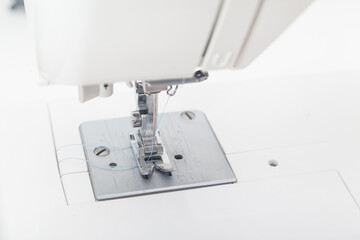 sewing machine needle against white background