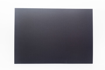 Fototapeta premium Closeup of black paper sheet against white background