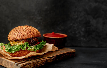 delicious hamburger on a stone background  
with copy space for your text