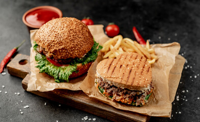 Fototapeta na wymiar heart shaped burgers and fries on stone background