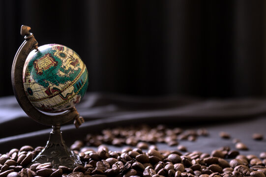 roasted coffee beans and atlas globe world commerce comodity
