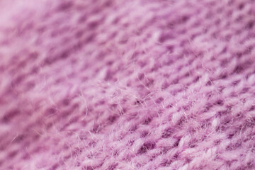 Knitted wool fabric texture background. Soft focus. Macro blur background. Pink woolen hand-knitted