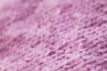 Knitted wool fabric texture background. Soft focus. Macro blur background. Pink woolen hand-knitted