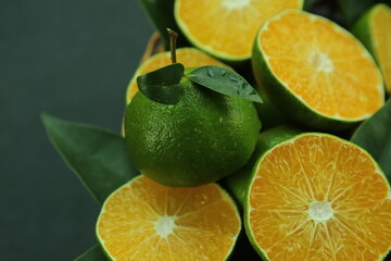 Green sweet tangerines growing with background