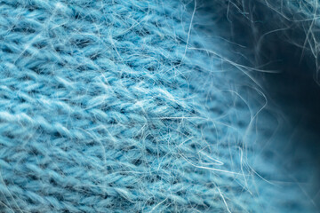 Knitted wool fabric texture background. Soft focus. Macro blur background. Blue woolen hand-knitted