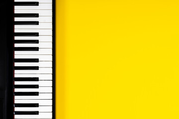 Top view to piano keyboard on yellow background. Music learning concept. Top view © vejaa
