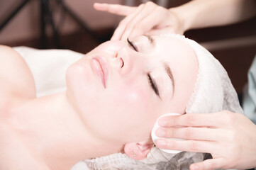 Fototapeta na wymiar Professional cosmetic facial massage in the spa salon