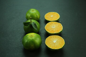 Green sweet tangerines growing with background