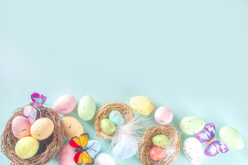Easter greeting card background with eggs, flowers and butterflies copy space