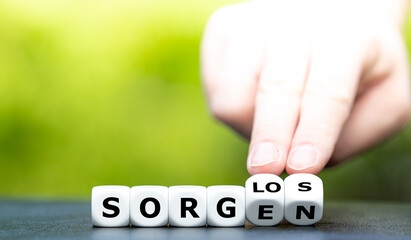 Hand turns dice and changes the German word 