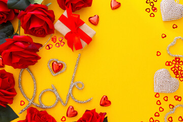 Valentine's Day mock up on yellow background with red roses, love word and hearts.