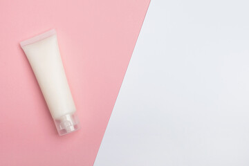 Cosmetic cream on light pink background. Beauty and skincare concept, layout for design. Top view, flat lay, copy space