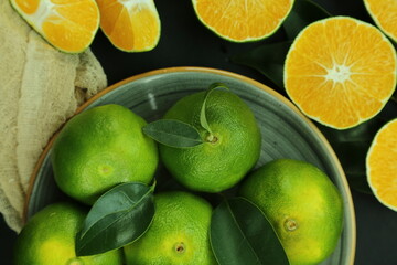 Green sweet tangerines growing with background