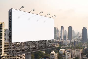 Blank white road billboard with Bangkok cityscape background at day time. Street advertising poster, mock up, 3D rendering. Side view. The concept of marketing communication to promote or sell idea.