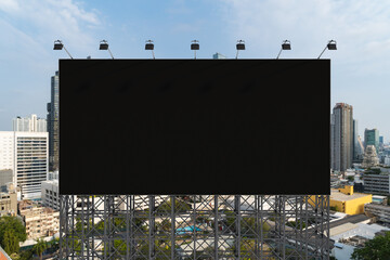 Blank black road billboard with Bangkok cityscape background at day time. Street advertising poster, mock up, 3D rendering. Front view. The concept of marketing communication to promote or sell idea.