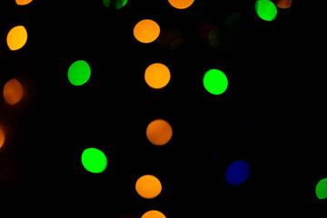 Texture of blurred bokeh colorful lights on black background