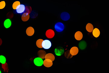 Fototapeta premium Texture of blurred bokeh colorful lights on black background