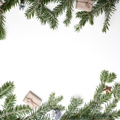 Christmas composition. Christmas gift, pine cones, fir branches on white. Top view, flat lounger, copy space.