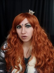 Naklejka premium red-haired queen. makeup. Black background