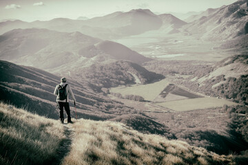 hiker in the mountains with lake in matese park