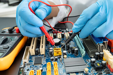 E-waste, technician repairing inside of hard disk by soldering iron. Integrated Circuit. the...