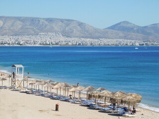 Piraeus, Greece . A popular beach on the city coast. The Athens coastline in the background