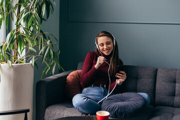 woman enjoying time listening music at her home