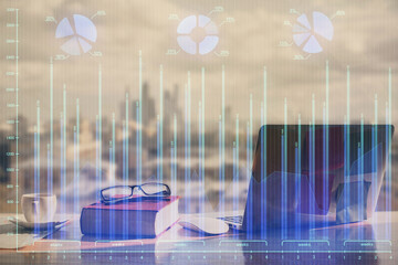 Double exposure of financial chart drawings and desk with open notebook background. Concept of forex market