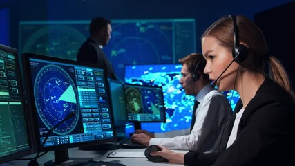 Workplace of the air traffic controllers in the control tower. Team of aircraft control officers works using radar, computer navigation and digital maps. Aviation concept.