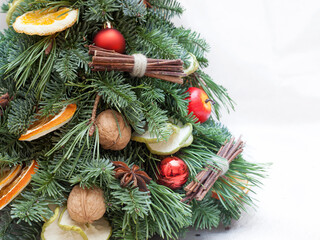 Christmas composition of fir tree branches, orange and apple slices, walnuts, anise and balls