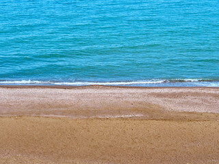 Fototapeta na wymiar Blue sea wave on clean coast with sandy beach