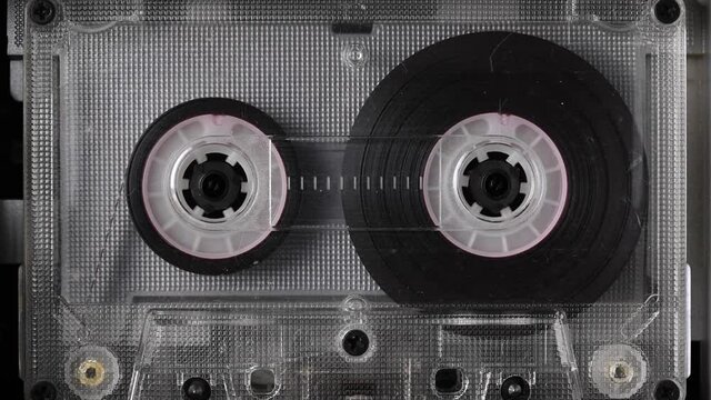 Vintage audio cassette tape playing. Rotation of rolls of film. Close up footage