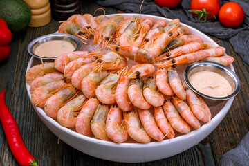 boiled shrimp on ice on dark blue table