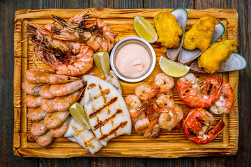 assorted seafood grilled on a Board on blue wooden table
