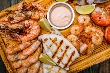 assorted seafood grilled on a Board on blue wooden table