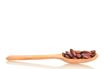 Organic red beans with a wooden spoon, close-up, isolated on white.