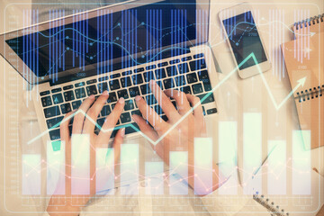 Double exposure of woman hands working on computer and forex chart hologram drawing. Top View. Financial analysis concept.